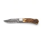 Damascus steel folding pocket knife with stag horn handle shown open in side profile on a plain white background