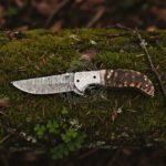 Damascus Folding Pocket Knife — Hand-Forged, Ram Horn Handle, Leather Sheath