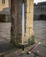 Elven sword replica standing upright against a weathered stone pillar with its scabbard, showing overall length and the leaf shaped steel guard