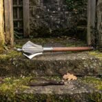 Hand forged high carbon steel flanged mace with walnut haft, full length on a mossy stone step with its leather wrist strap