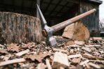 Hand forged high carbon steel medieval war hammer with beak spike and hammer face, low view of the head by a chopping block
