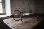 Italian rapier with blackened swept hilt, gilt finials and twisted wire grip resting on an old table by a window