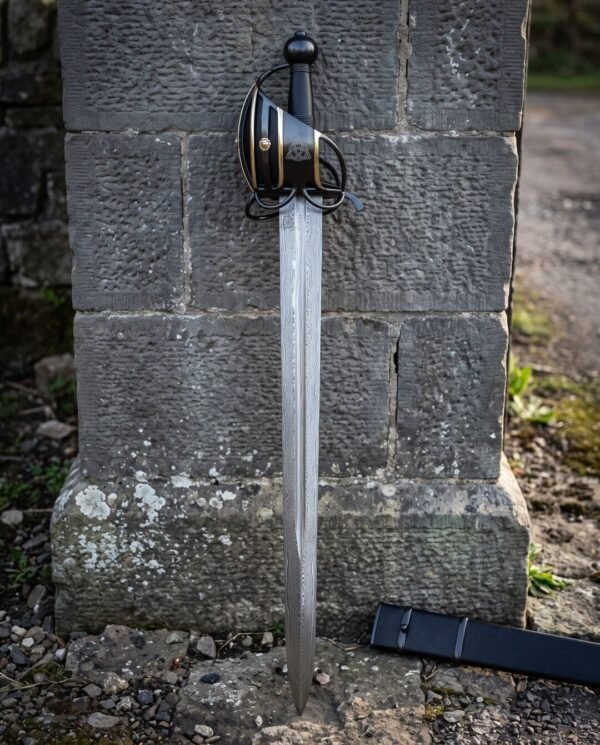 Blackened basket hilt broadsword, brass banding across the cage and a thirty one inch Damascus blade