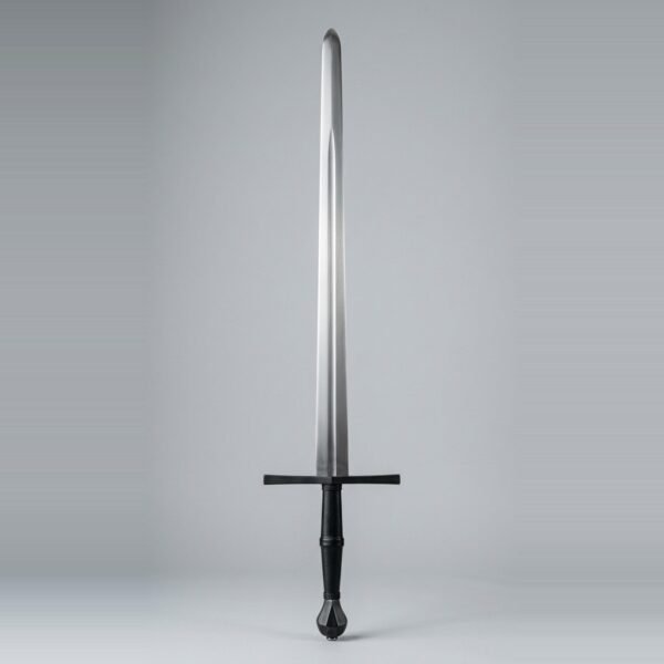 Blackened blunt longsword trainer with a dark cross and pommel, black leather grip and a fuller running two thirds of the blade shown against a plain studio backdrop