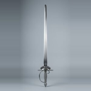 Blackened smallsword trainer with a pierced oval shell guard, olive pommel and dark wire bound grip standing point up against a plain grey studio backdrop