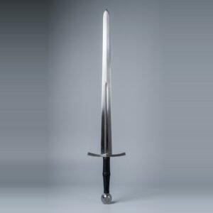 Blunt longsword for sparring with a fuller to mid blade, wheel pommel and black leather grip standing point up against a plain grey studio backdrop