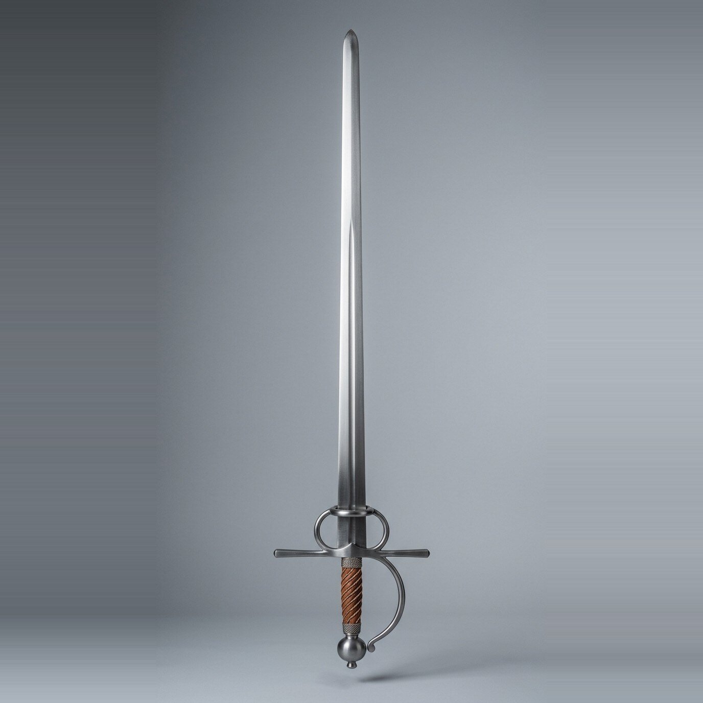 Elmgarth Bolognese Sidesword Trainer RK-3011 Bolognese sidesword trainer with two finger rings, a knuckle bow and russet leather wrapped grip standing point up against a plain grey studio backdrop