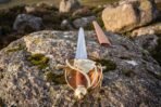 Brass knuckle bow and ball pommel over a tan leather wrapped grip