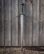 Broad Damascus blade with a long central fuller under a blackened scrolled crossguard