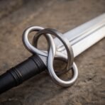 Close up of the interlaced steel loop guard with knurled texture and black leather grip of a fantasy sword