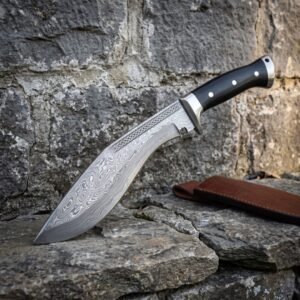 Damascus kukri knife with black micarta handle and engraved spine, angled on rough stone against an old stone wall with a leather sheath
