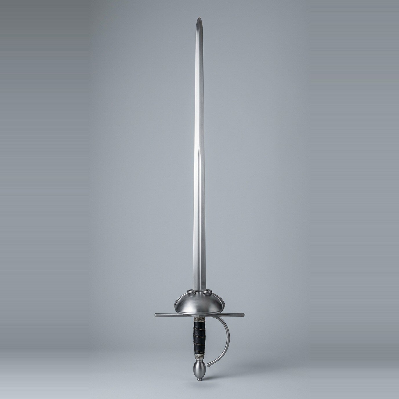 Dished shell rapier trainer with long quillons Dished shell rapier trainer with two small rings on the guard, unusually long quillons, black leather grip and an olive pommel shown against a plain studio backdrop