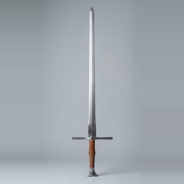 Fishtail pommel longsword with a squared wide ricasso, tan leather and cord grip standing point up against a plain grey studio backdrop