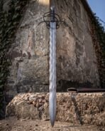 Flame bladed Damascus sword with a brown leather scabbard and a steel throat
