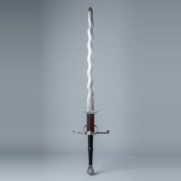 Flame bladed greatsword with waved edges on both sides, scrolled quillon tips, a side ring and a leather wrapped ricasso above the parierhaken laid on a plain grey studio backdrop
