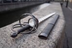 Flame bladed short sword with its black leather scabbard, steel locket and chape fitted