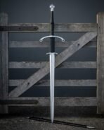 Full length two handed longsword with black leather grip standing upright against a grey wooden gate above its scabbard