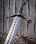Green wrapped grip over a shaped core, closed at each end with brass collars