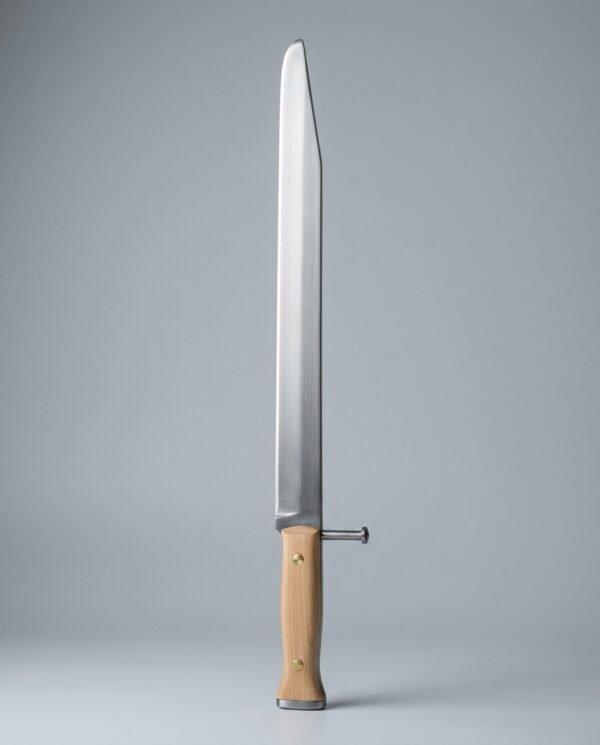 Grosses messer trainer with a side nagel and no crossguard, two brass rivets through pale wood scales and a blunted clipped point, laid on a plain grey studio backdrop