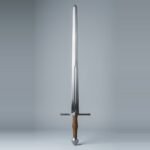 Hand and a half blunt training sword with a broad double edged fullered blade, faceted globe pommel and tan cord wrapped grip against a plain studio backdrop