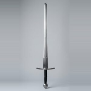 Hand and a half trainer with a narrow fuller, wheel pommel and black waisted leather grip standing point up against a plain grey studio backdrop