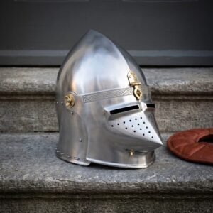Hand forged medieval helmet in the pig faced bascinet pattern, satin 18 gauge steel with a hinged hounskull visor and brass mounts, on grey stone steps