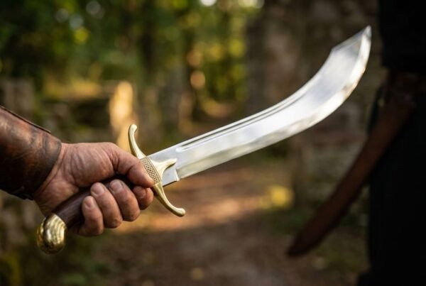 Hand holding a deeply curved steel scimitar with brass guard and wooden grip out over a sunlit forest path