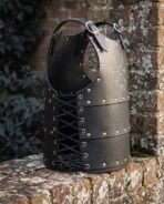 Hand made black leather Viking cuirass, side view showing the laced side panels and buckled shoulder straps on a brick ledge