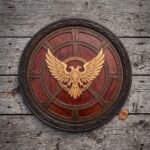 Hand made carved hardwood double headed eagle shield in deep red brown with a pale gold twin headed eagle carving, blackened steel rim and knotwork band on weathered planks