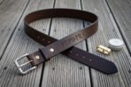 Hand made dark brown leather rune belt with stamped Elder Futhark line, looped on decking with brass fittings and a tin of balm