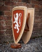 Hand made wooden heater shield with painted rampant lion and knotwork border, front and back views propped against a brick wall