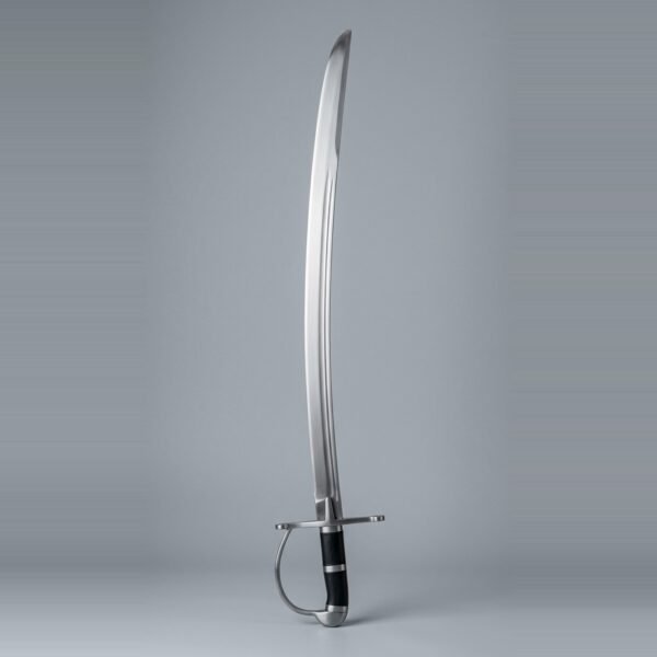 Hanger sabre trainer with a curved single edged blunt blade, D shaped knuckle bow and black leather grip laid against a plain studio backdrop