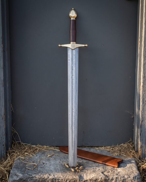 Helm of Awe arming sword with an etched Damascus blade, brass crossguard carrying the eight armed stave, burgundy leather grip and tall brass acorn pommel on stone