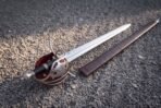 Helm of Awe stave cut across the lower shell of a satin finished broadsword