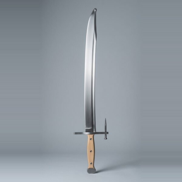 Langes messer trainer with a long forward angled nagel spike, rounded clipped point and blonde wood scales on three rivets standing point up against a plain grey studio backdrop
