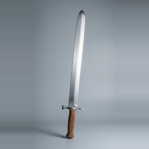 Langes messer trainer with a rounded tip, mushroom head nagel and brown scales on three steel rivets standing point up against a plain grey studio backdrop