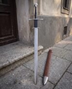 Long Damascus blade under a straight crossguard and a second down swept guard, black leather grip
