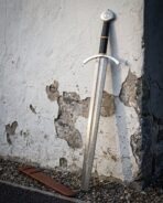 Pattern welded arming sword with its brown leather scabbard, swept guard and black wrapped grip