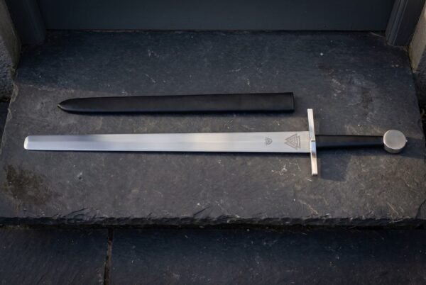 Plain square bar guard above a satin finished thirty inch double edged blade