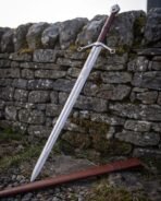 Polished guard with clover shaped terminals, oxblood grip and a steel wheel pommel with a raised boss