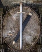 Polished steel arming sword with brass wheel pommel, brass cross guard and pale leather grip over its black scabbard on a log