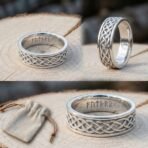 Polished steel ring with a Celtic knotwork band and Elder Futhark runes cut inside, shown from two angles on a sawn log with a suede pouch