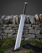Rune sword with a sawtooth spine and Elder Futhark etching standing against a dry stone wall in a grass field beside its black leather scabbard