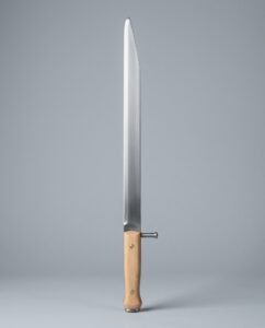 Sharp bauernwehr long knife with a side nagel, pale wood scales and an acute clipped point shown against a plain studio backdrop