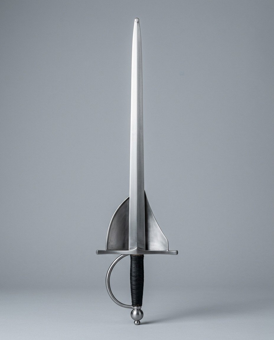 Ceravalt Shell Guard Rapier RK-3020 Shell guard rapier trainer with paired triangular shell plates, ball pommel, black leather grip and a ridged blade standing point up on a plain grey studio backdrop