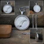 Silver tone bifrost pendant with rope twist border and heavy curb chain on stone, with front, back and edge detail insets