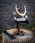 Steel kabuto helmet with ribbed bronze bowl, polished crescent crest and blue laced neck guard on a wooden stand