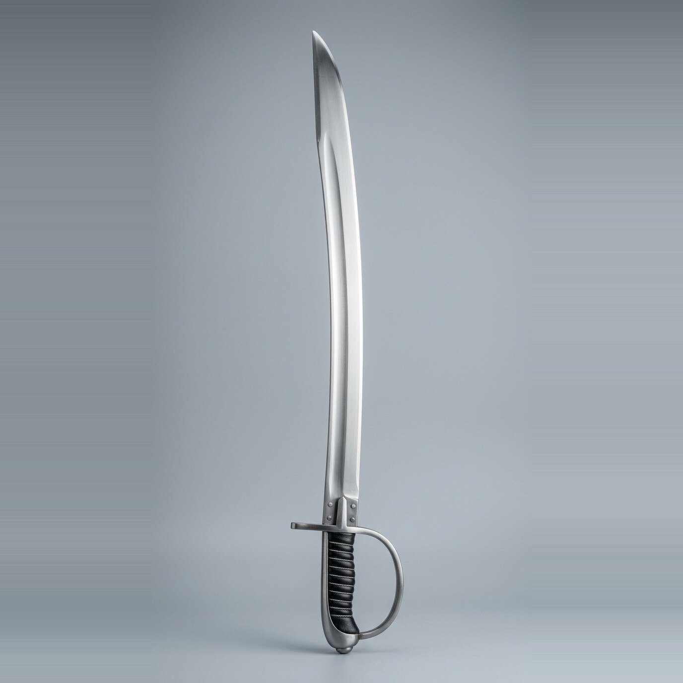 Stirrup hilt sabre trainer Stirrup hilt sabre trainer with a single D shaped knuckle bow, one quillon, wire over leather grip and a backstrap cap shown against a plain studio backdrop
